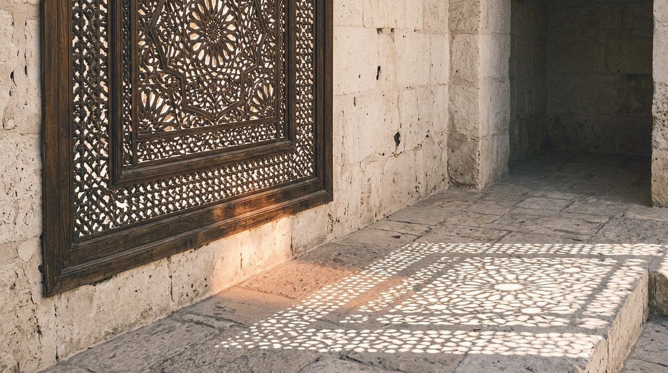 Carved wooden mashrabiya screen casting patterned shadows on a limestone floor